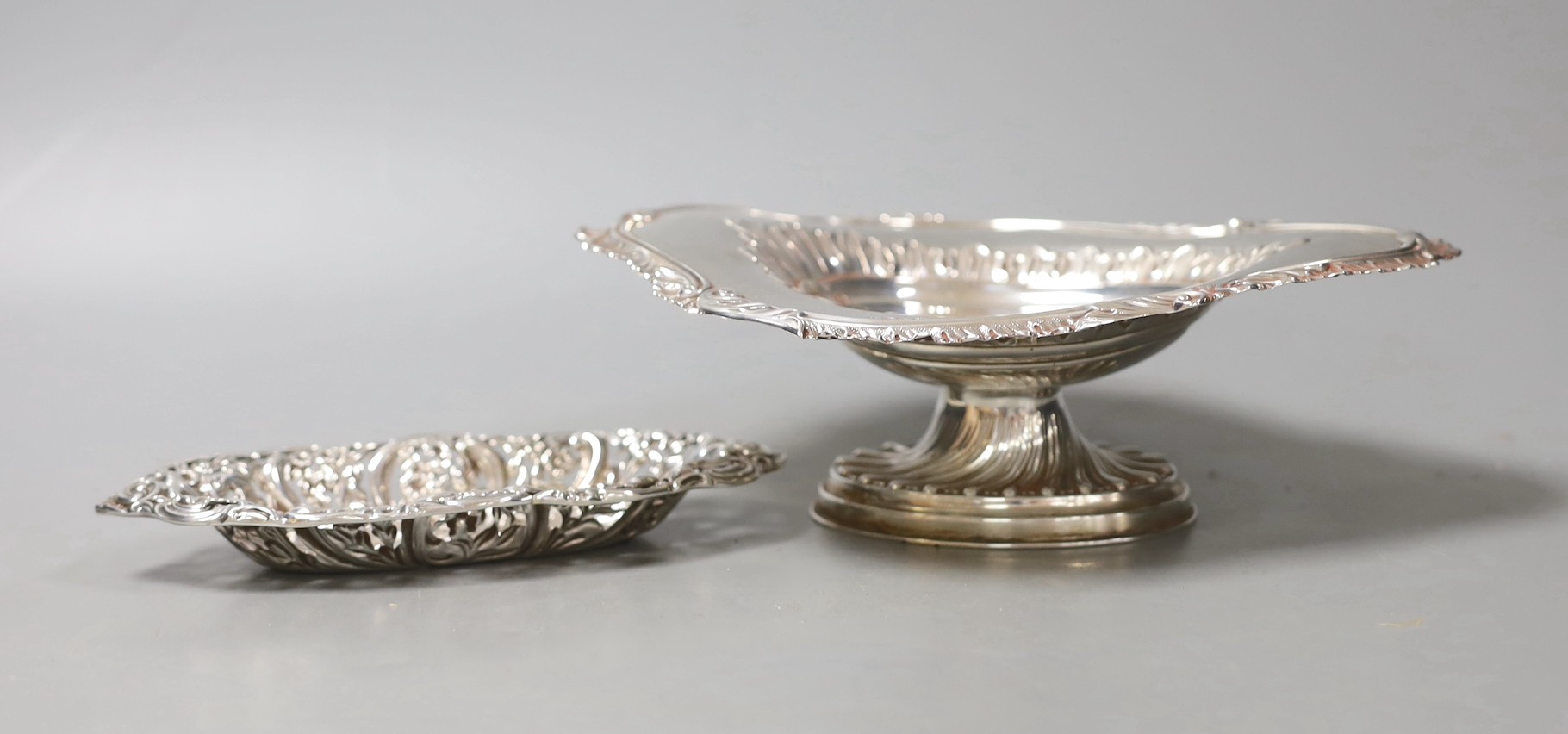 A late Victorian silver oval pedestal dish, James Deakin & Sons, Chester, 1894, 22cm and a similar repousse silver bonbon dish, 6.5oz.